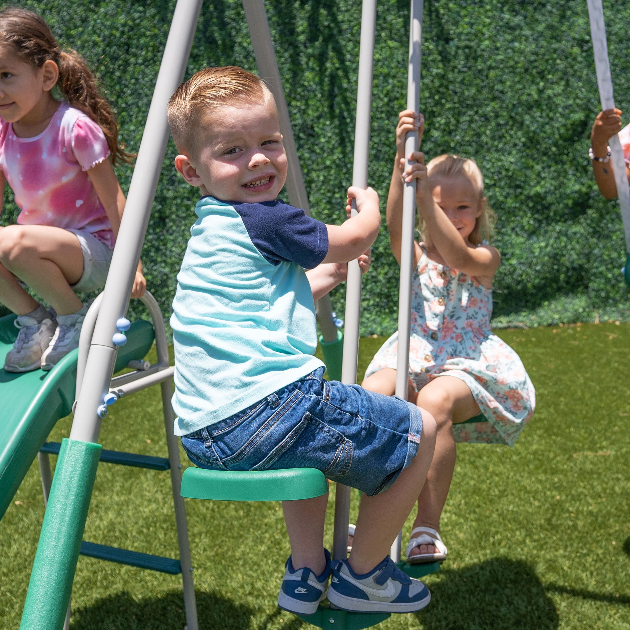 The Swing Company Yonkers Metal Swing Set with Glide Ride Trapeze Bar and 5 ft Slide (Green, 133.2 in L x 99.6 in W x 73.2 in H) bx4vy